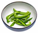 Fresh Green Bell Pepper Slices in a Bowl Isolated on White with a Clipping Path.