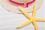 Beach Background with Hat and Bright Yellow Starfish.