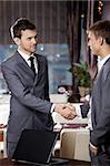 Two business men shake hands each other at a meeting at restaurant