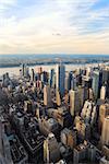 New York City Manhattan sunset skyline aerial view with office building skyscrapers and blue sky.