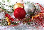 Christmas balls surrounded by green branches and decoration