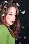 Teenage model with flowers and butterflies in her hair