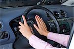 Young woman pressing on horn signal button