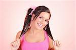 Beautiful happy woman with funny dual pony tails hairstyle. pink background