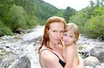 mother daughter playing in river after swimming outdoor nature