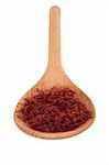 Saffron spice in a wooden spoon over white background. Selective focus.