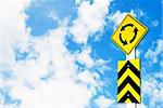 traffic circle road sign on beautiful sky background
