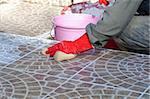 Close up of construction worker installing decorative tiles