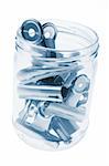 Bulldog Paper Clips in Glass Jar on White Background