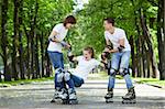 Two young people lift the fallen girl on rollers