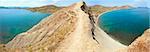 Summer rocky coastline and camping on sandy beach (Tihaja Bay (Koktebel Town in left), Crimea, Ukraine ). All peoples and cars is aunrecognizable, Three shots stitch image.