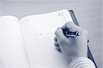 Businessman writing a note at his workplace.