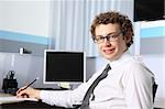 Portrait of a young business man working at office