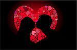 Silhouettes of lovers kissing on the background of the heart