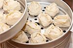 Metall steam cooker with oriental dumplings (manty)