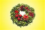 Christmas decoration wreath over yellow background