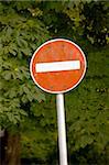 No entry traffic sign with tree in the background