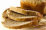 Loaf of bread and bread slices isolated on white background