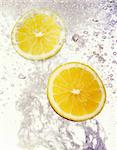 Fresh lemons dropped into water