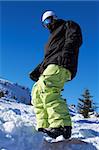 Snowboarder standing on board in Italian Mountains
