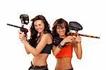 Two young beautiful girls posing like playing paintball