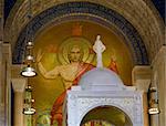 Basilica of the National Shrine of the Immaculate Conception in Washington DC showing interior of upper church and mosaic of Christ on ceiling above the altar