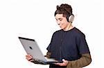 Teenager with headset makes internet mp3 music download at computer. Isolated on white background.