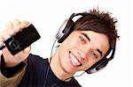 Happy male Teenager with headphones shows mp3 music player. Isolated on white background.