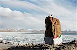 Landscape of a big rock at lakeside in Tibet