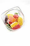 delicious sweet candies in sugar in a glass jar. white background
