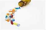 a colorful stream of pills coming from a pill bottle - on a white background