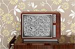 retro wooden tv on wooden vitage 60s furniture floral wallpaper