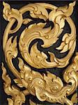 Wood carvings is a form of Thai art and painted black paint over the designs with gold