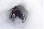 Child playing in snow tunnel