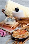 Spa composition: handmade soap, bath salt, moisturizer, towel, orchid flowers