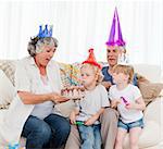 Children blowing on the birthday cake at home