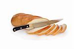 Kitchen knife and sliced fresh-baked long loaf of bread isolated on white background