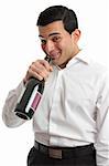 A tipsy or drunk man party goer drinking directly from a wine bottle