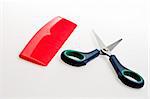 isolated red comb and blue scissors