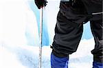 A trekker standing in front of a mulan, shot in Alaska