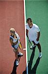 happy young couple playing tennis game