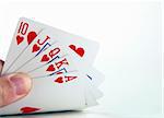 A royal flush in hearts isolated on a white background
