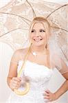 beautiful bride in white wedding dress with accessories. umbrella