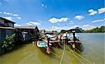 colorful longboats at a pier in the Phang Nga Bay