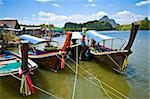 colorful longboats at a pier in the Phang Nga Bay