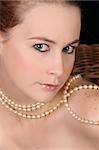 Close up of beautiful female wearing pearls