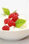 Dieting cottage cheese with tasty fresh raspberry