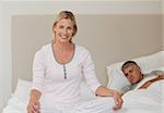 Lovely woman practicing yoga on her bed