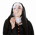 Young nun on white background blowing bubbles