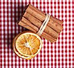 Dried Orange and Cinnamon Sticks on chequered cloth